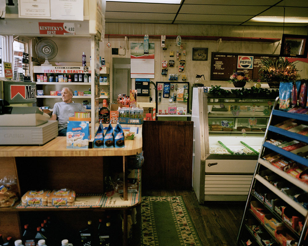 USA / Ohio / Utopia / May 2016. Utopia is made up of a few houses, and about 30 inhabitants, along the Ohio River. It's a very desolate place. When I asked Willie Franklin, who has run Utopia's only Village Market and gas pump for 34 years with his wife Ursula, if anyone ever passes by, he said "Yes, a few people during the summer. People come here to camp along the river. I'm the only one who sells gas and food supplies within miles." Utopia was founded in 1844 by followers of the French philosopher Charles Fourier (1772-1837). Fourierism, based on utopian socialism and the idea of equal sharing of investments in money and labour, reached peak popularity in the United States from about 1824 until 1846. The experimental community of Utopia dissolved in 1846 due to lack of fiancial success and disenchantment wth Fourierism. John Wattles, leader of a society of spiritualists, puchased the land and brought his followers. The spiritualists, who sought secluded areas to practice their religion, built a two-storey brick house and later moved it brick by brick to the river's edge despite warnings from the locals. A flash flood on December 13, 1847, drove most of the inhabitants to seek shelter in the town hall, being the only solid building, and almost all drowned or died of hypothermia. The settlement was then bought and re-organized by American anarchist Josiah Warren as an individualist anarchist colony. By 1850 the community had 40 buildings, about half of which were of industrial nature. But the rising prices of surrounding land that made expansion difficult and the strict requirement of being invited by the original settlers led to the eventual dissolution of the colony in 1856. ©Marta Giaccone